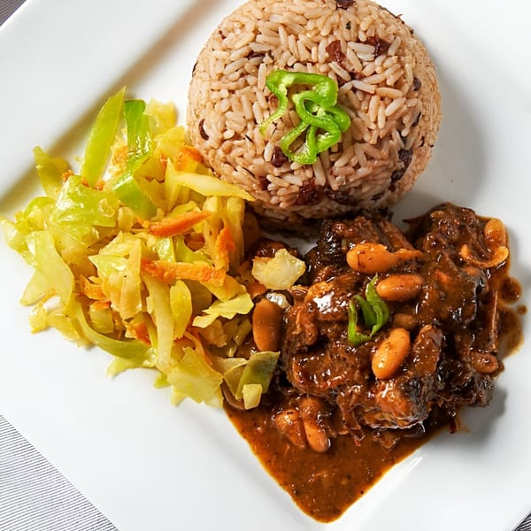 Jamerican Kitchen Cafe's Jamaican oxtail stew with rice and peas, and steamed cabbage.
